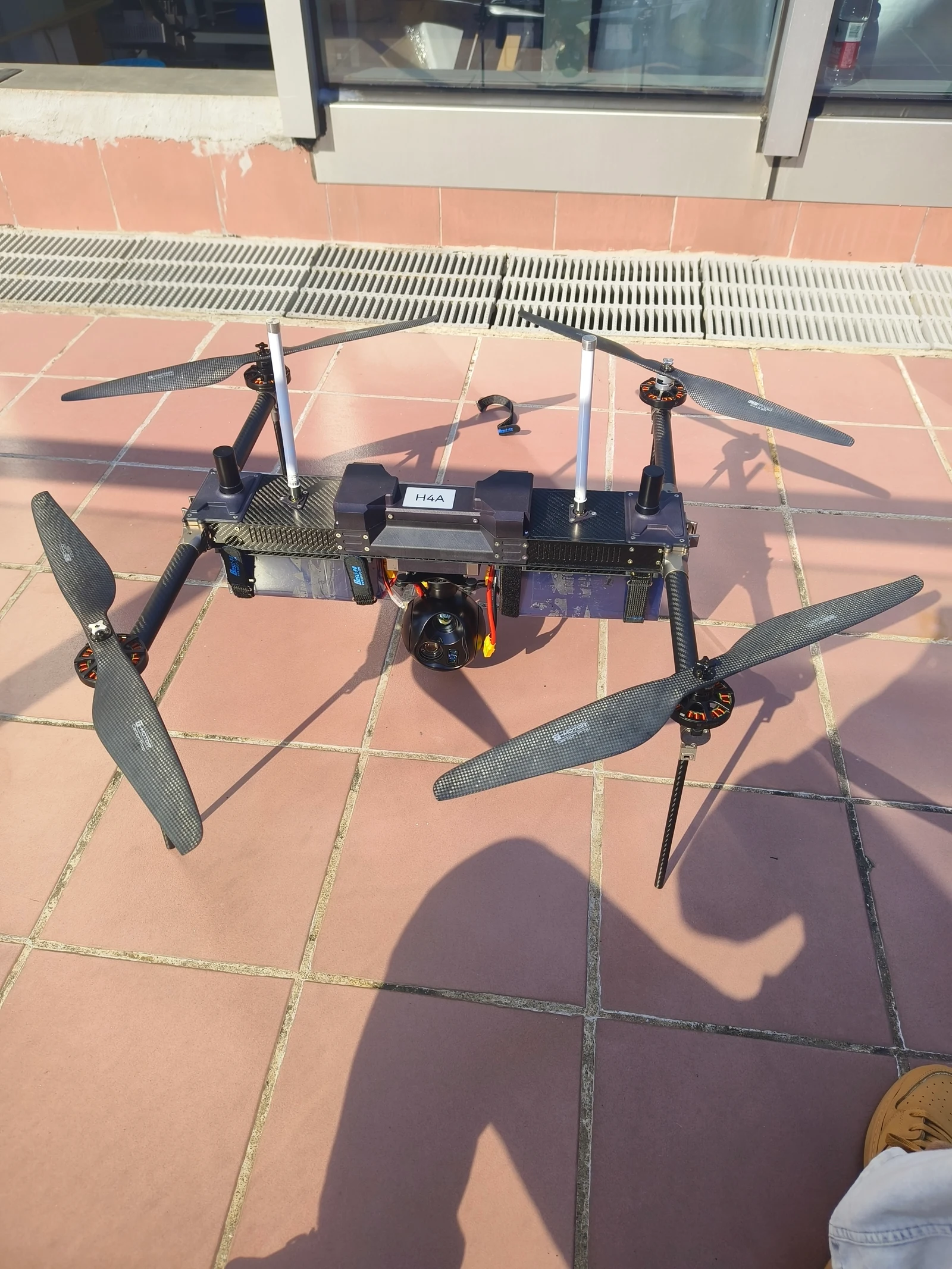 XJ-H4A long-endurance drone flying beside its RTK base station and professional ground controller.